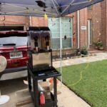 Texas Frozen Tropics machine set up under a tent at an early graduation party rental