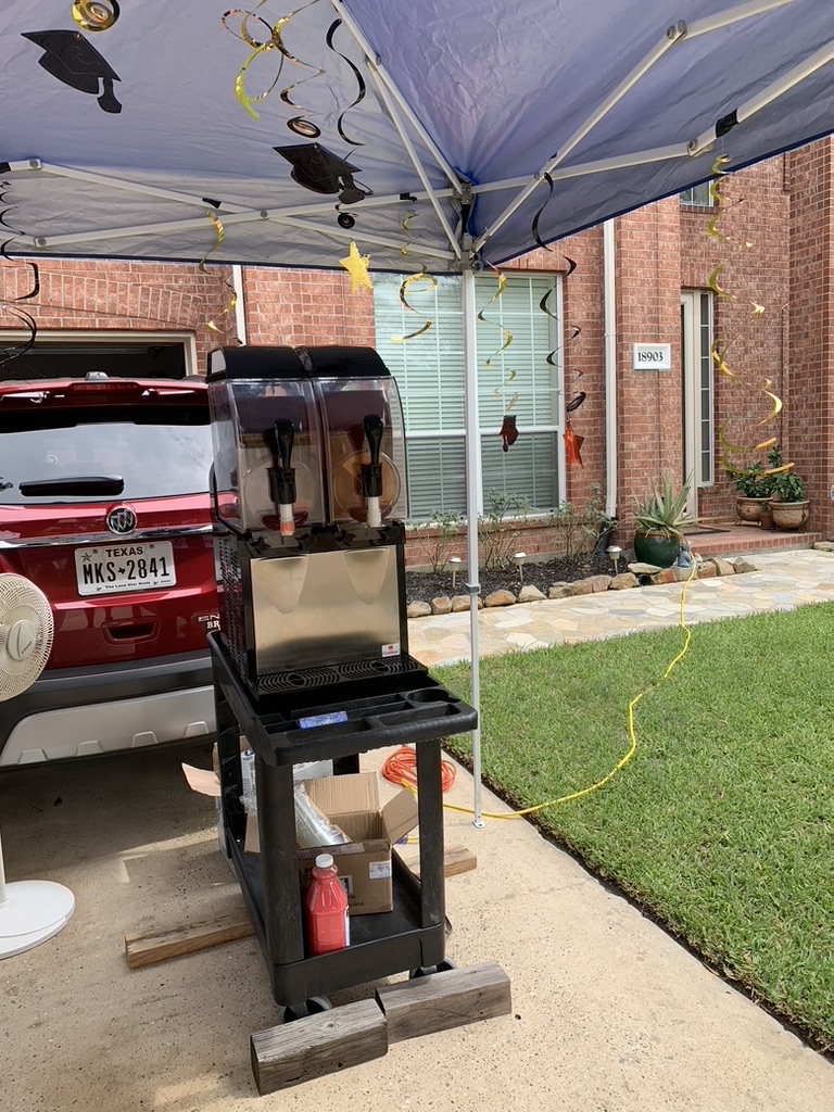 Texas Frozen Tropics machine set up under a tent at an early graduation party rental
